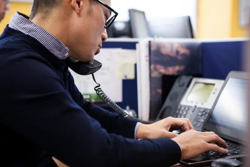 Office worker using a VoIP phone