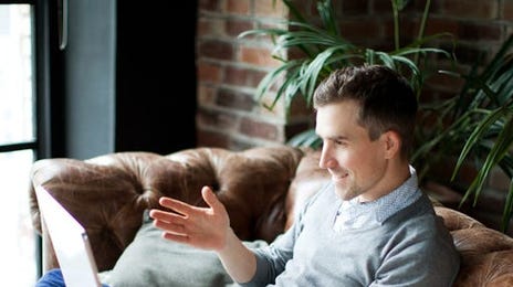 A man sitting on his couch and a test lesson with Berlitz