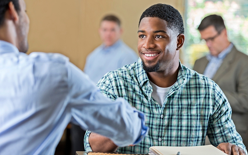 An job applicant interviews for a warehouse role.