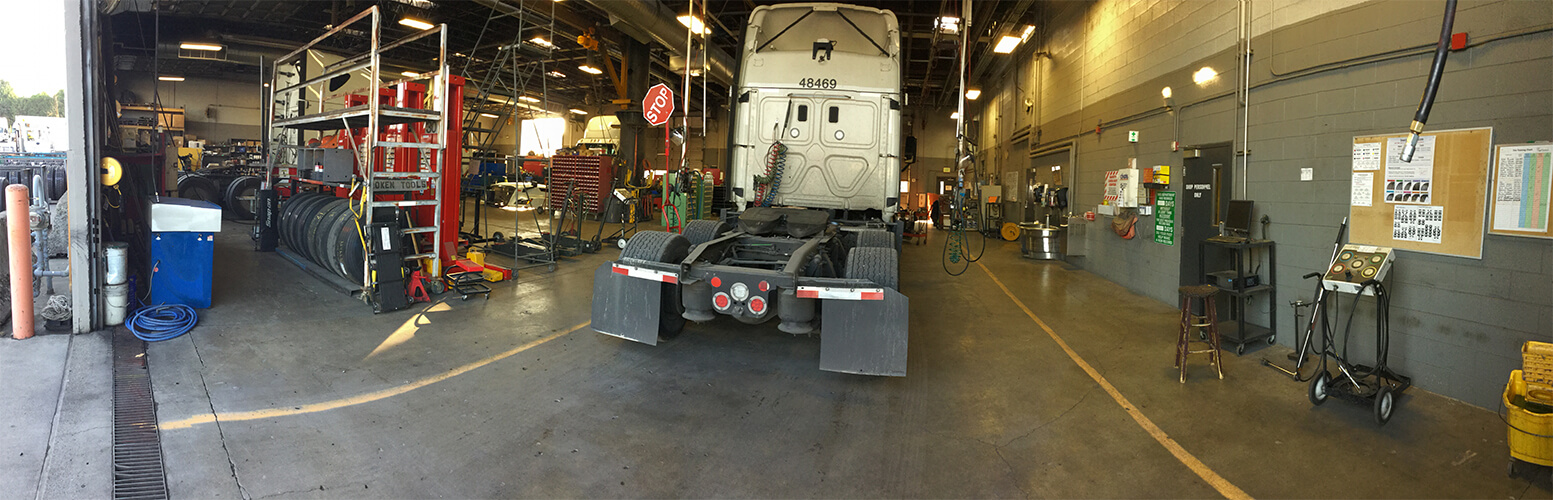 A truck awaits service in a Schneider maintenance shop.