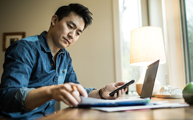 A man sits down to work on a truck driver budget.