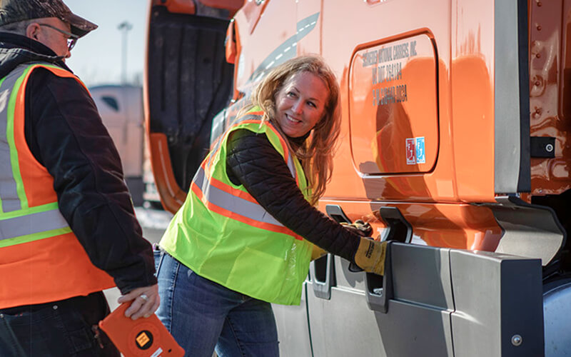 Schneider training engineer Kellylynn McLaughlin walks a trainee through a pre-trip inspection.