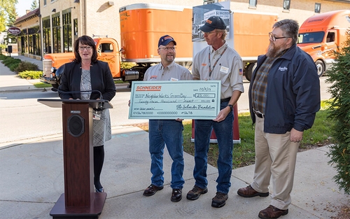 The Schneider Foundation presents a large check for $23,000 to NeighborWorks Green Bay