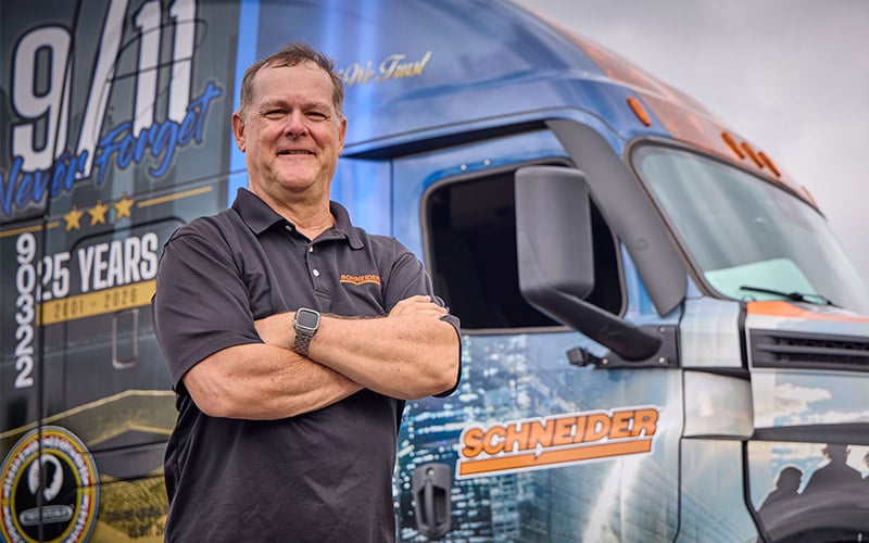 Schneider driver Greg Smith standing in front of the 2026 Ride of Pride truck.