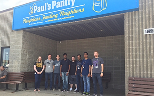 Schneider interns gather in the entryway of Paul’s Pantry.