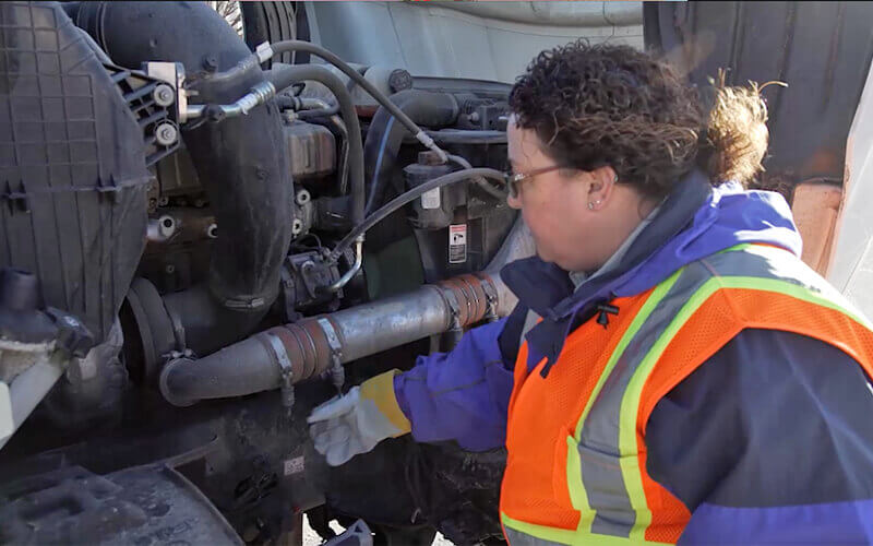 Schneider Driver Instructor Dana performs a CDL pre-trip inspection.