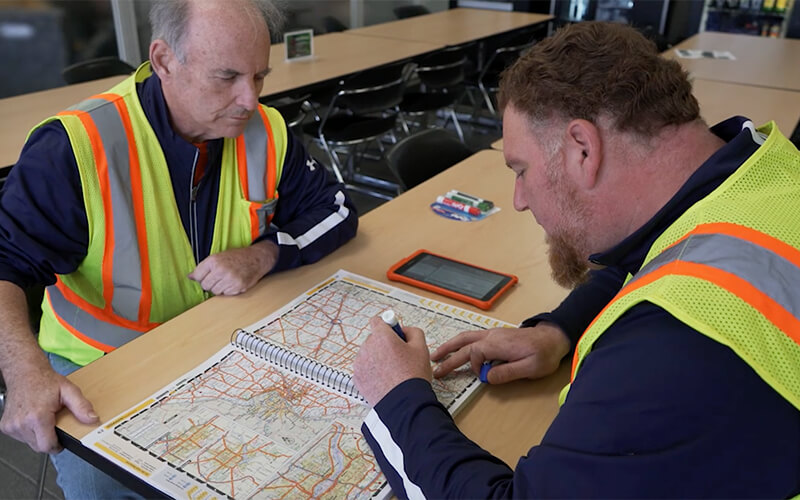 Schneider Team drivers do some trip planning at a driver lounge.