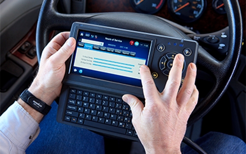 A Schneider driver navigates the features of his company-provided tablet.