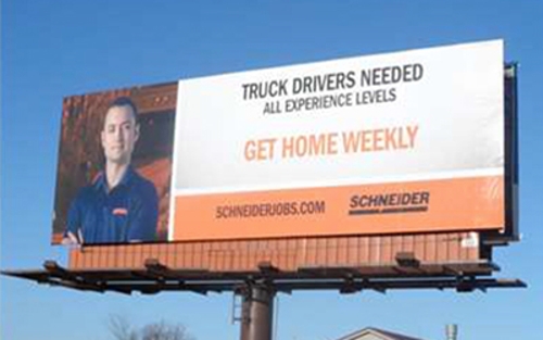 Schneider billboard reads "Truck drivers needed. All experience levels. Get home weekly. schneiderjobs.com"