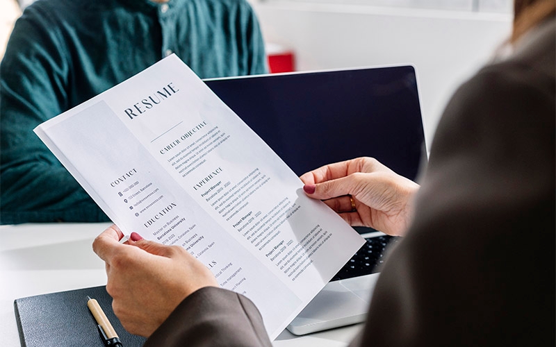 A person reviewing a job candidate's resume.