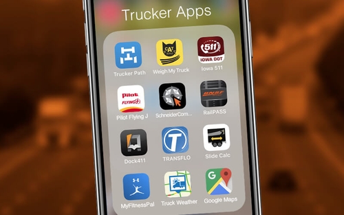 An app folder titled "Trucking Apps" includes Trucker Path, Weigh My Truck, Iowa 511, Pilot Flying J, SchneiderCompass, RailPASS, Dock411, TRANSFLO, Slide Calc, MyFitnessPal, Truck Weather and Google Maps.