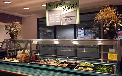 The Fresh Market build your own salad bar with an assortment of toppings and dressings.