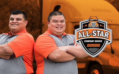 Carlos and Sergio Villarreal pose back-to-back with a Schneider All-Star Company Driver badge.