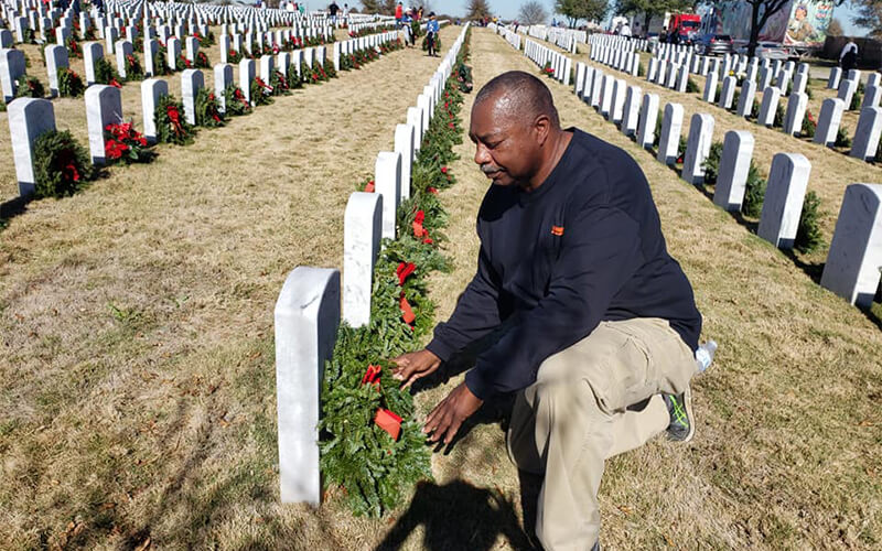 Randy Twine placing wreaths at soldiers' graves for Wreaths Across America