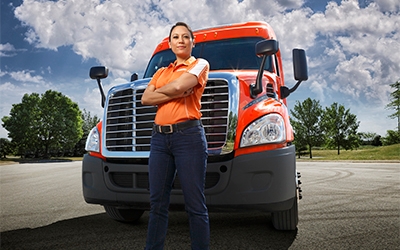 A female Schneider truck driver with her company truck.