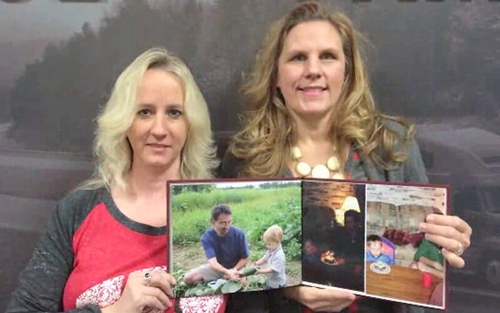 Schneider associate Amy holds up a photo album memorializing her husband Jim with help from her leader Jennifer