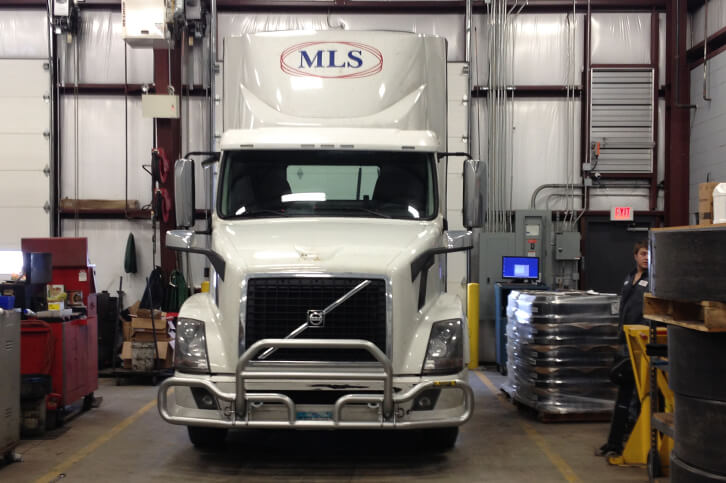 An MLS tractor parked inside a maintenance bay at an MLS facility