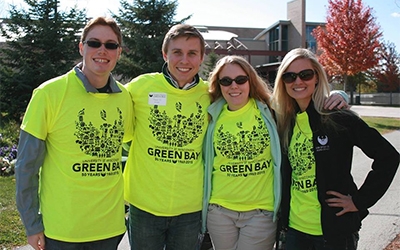 Schneider associate Vanya gathers with fellow members of the UW-Green Bay alumni board while visiting campus.