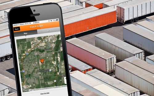 Schneider's 'Find a Trailer' app beside a lot that's full of containers