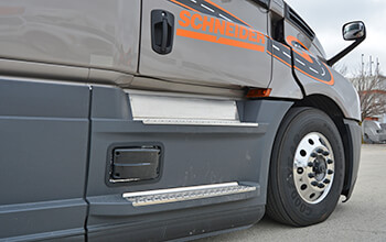 A sensor is attached to the passenger side of the 2022 Freightliner Cascadia to detect lane departure.
