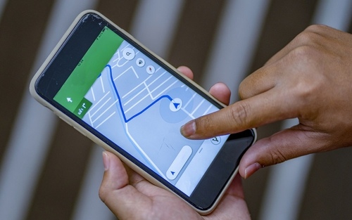 A truck driver using a GPS app to preview their route.