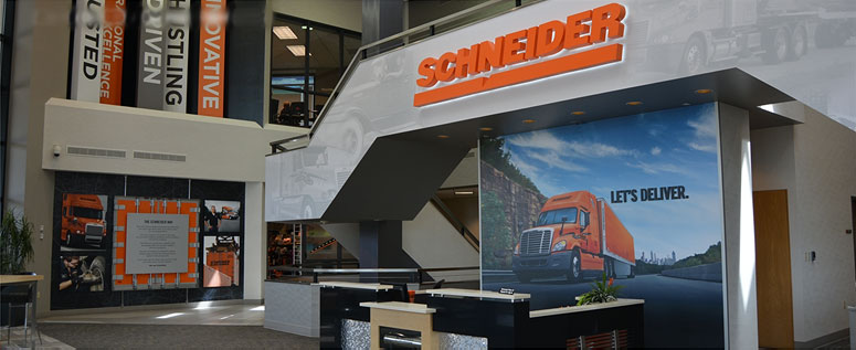 A modern lobby area welcomes guests with various Schneider-themed displays at the company's corporate headquarters in Green Bay, Wis.