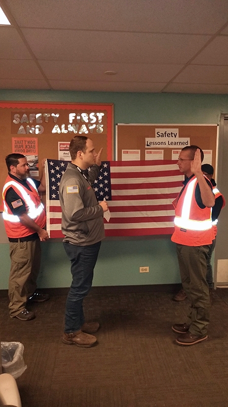 Operations Manager Corey Dyke performs the reenlistment ceremony for Intermodal driver Don Antle.