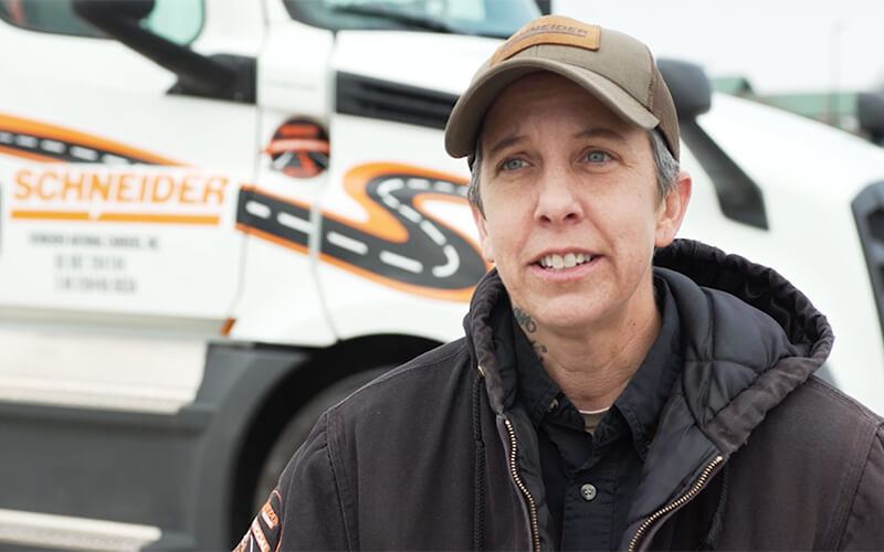 Schneider 2019 Featured Female Truck driver Elizabeth stands in front of her company truck