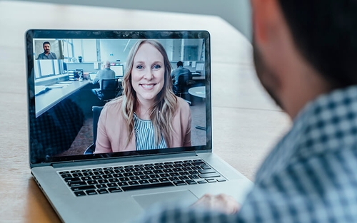 A job searcher interviews with a potential employer over a video call.