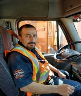 Chris behind the wheel of his company truck.