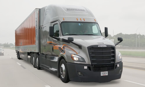 Schneider VTL Truck driver driving down highway.