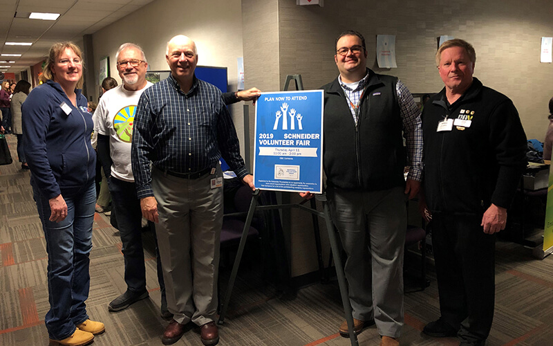 Schneider associates and local organizations meet in the hallways of Schneider's corporate headquarters during the company's annual volunteer fair.