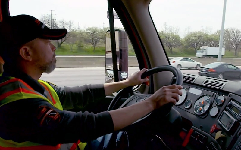 A Schneider driver behind the wheel of their truck.