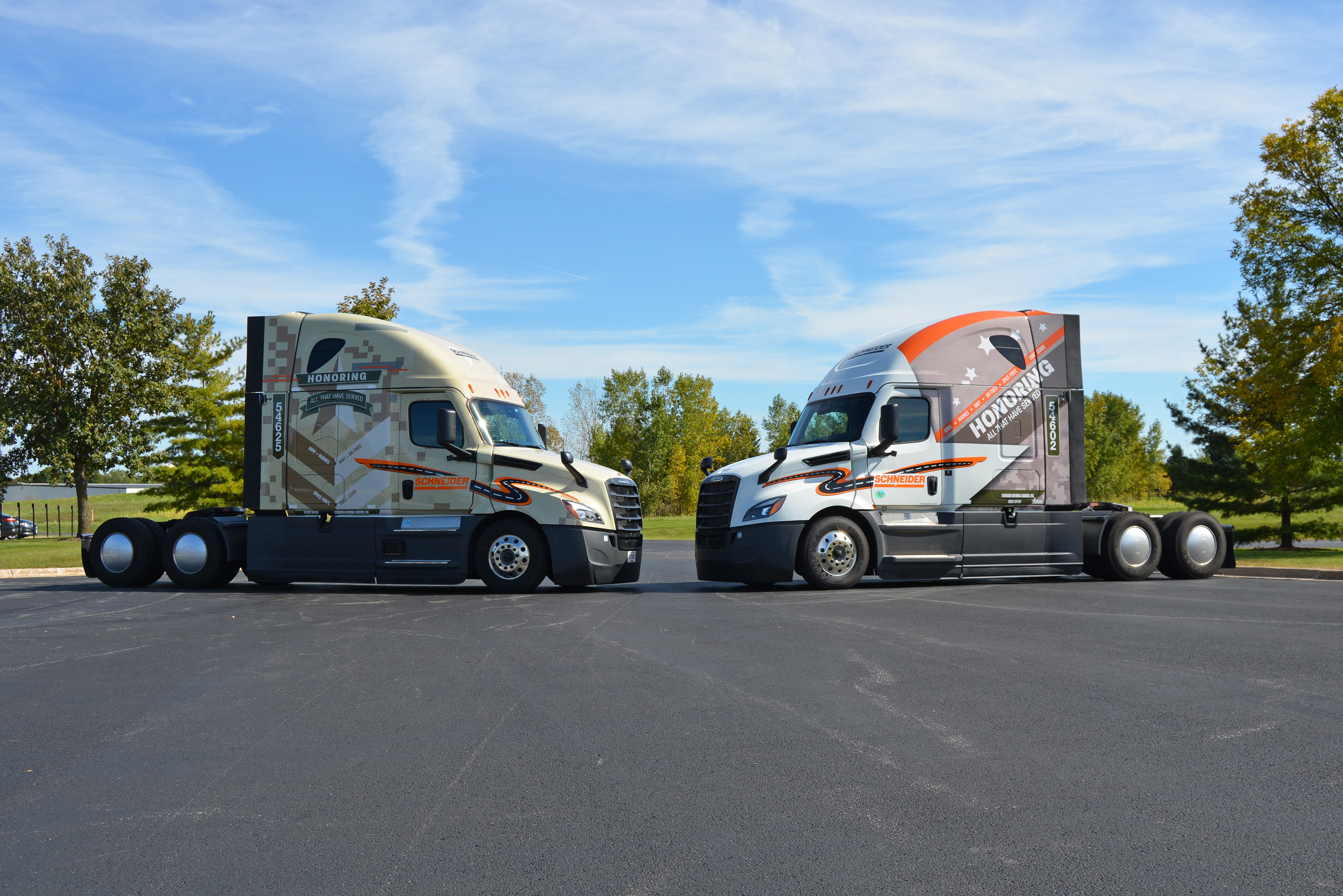 Two of Schneider's newest military-wrapped tucks.