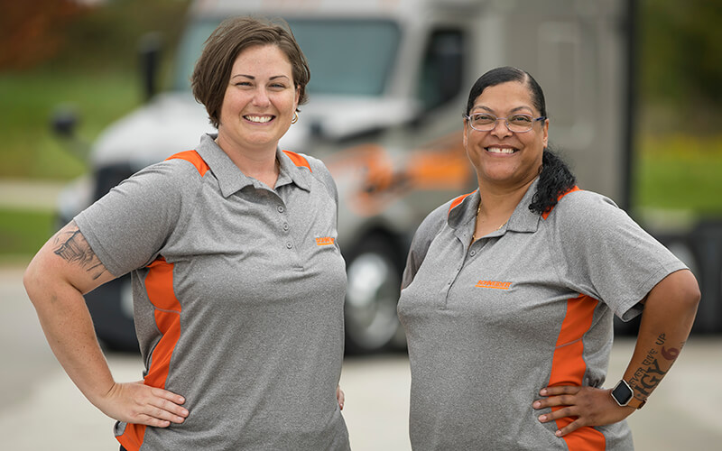 2018 Schneider Featured Female Truck Drivers Lisa and Patrice pose in front of their company truck