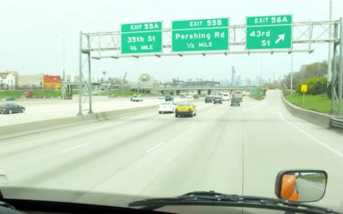 A semi-truck keeps a safe following distance on the highway.