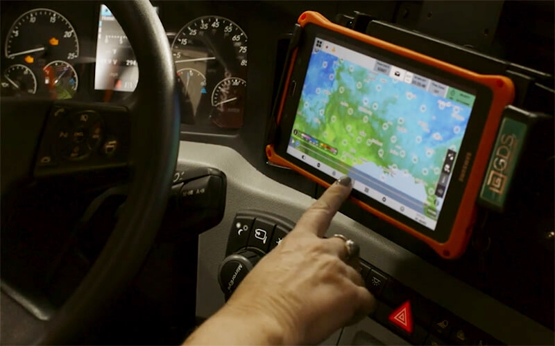 A Schneider driver uses their tablet to access weather data.