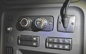 The 2022 Freightliner Cascadia APU control panel features climate control options, automotive power socket and a light.