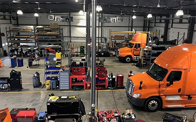 The service bays are lined with specialized tools and equipment for diesel technicians.