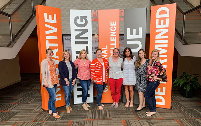 Schneider female associates gather in the company's corporate office.