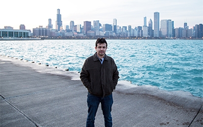 Schneider intern Ahsan Rehman stands along the canal in Chicago.