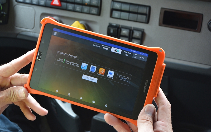A driver accesses the features of their handheld Schneider tablet.