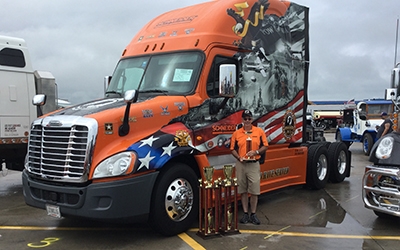 Jay Hull shows off his two first-place trophies alongside his award-winning 2015 Ride of Pride truck.