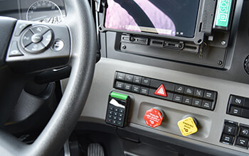 A small SmartDrive keypad is attached to the dash of the vehicle and can be seen behind the steering wheel.
