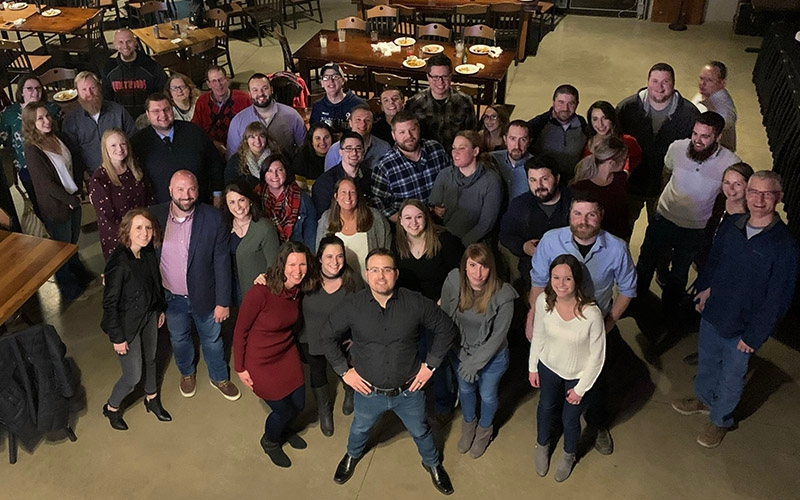 The Schneider Power Only team poses together at a restaurant.