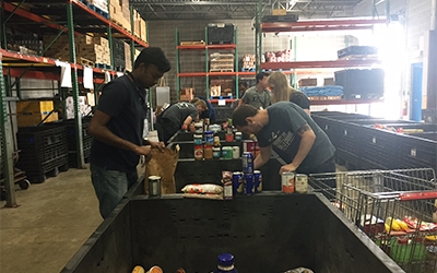 Schneider interns sort food at Paul’s Pantry.