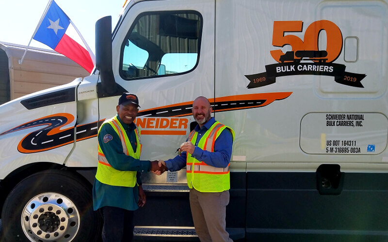Ed and his leader pose together in front of his new 50th Bulk Carriers Anniversary decal.