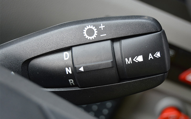 The black automatic manual transmission gear shift, located on the right hand side of the truck steering column, is set to neutral.