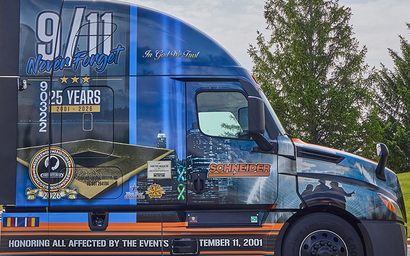 The passenger side of Schneider's 2026 Ride of Pride truck. The truck wrap represents the 9/11 memorial pools and the 2,983 names inscribed into bronze parapet surrounding the pools.