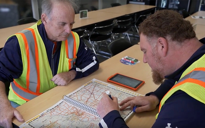 Schneider team drivers plan their driving time at a company driver lounge.